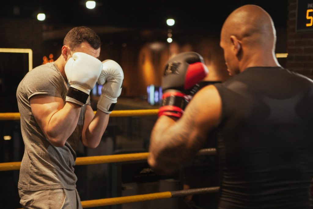 2 men playing against each other during a boxing match