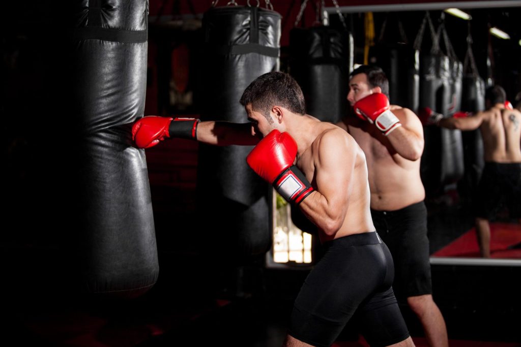 2 men playing boxing at the gym