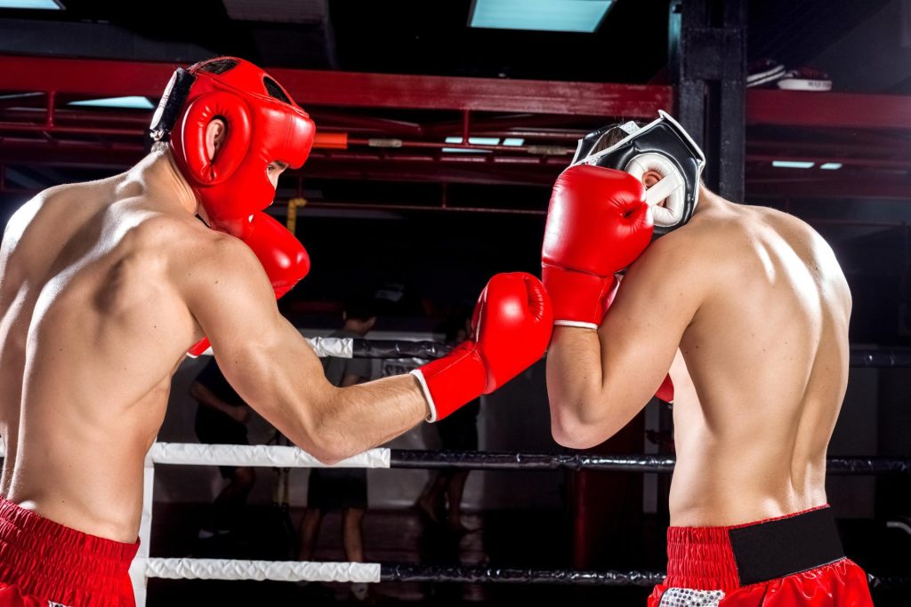 2 men playing against each other during a boxing match