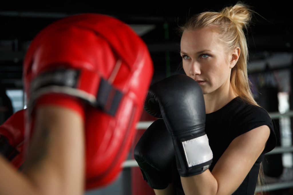 2 girls playing boxing together